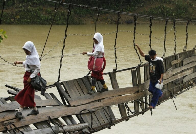 Morning Feeding: Indonesian Children Make Perilous Journey To School Over Collapsed Bridge