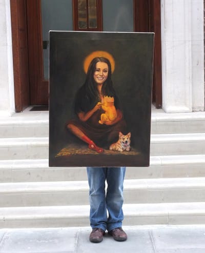 Artist Kaya Mar holds a portrait of Catherine, Duchess of Cambridge on the steps of the Lindon Wing of St Marys Hospital