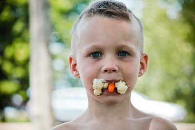 boy with carrots in mouth