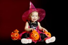 little-girl-dressed-as-witch-with-pumpkin