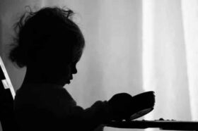 child looking at empty bowl
