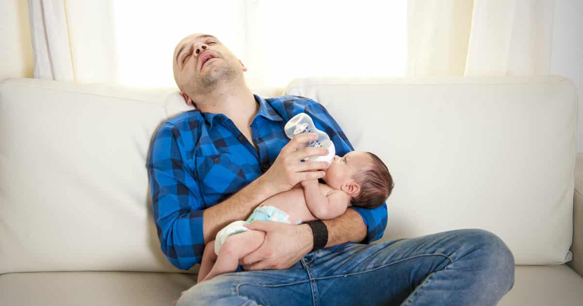 new father asleep with baby
