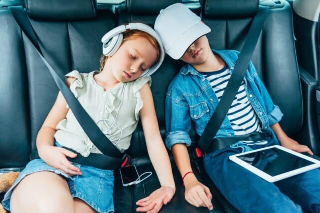 kids on headphones in car