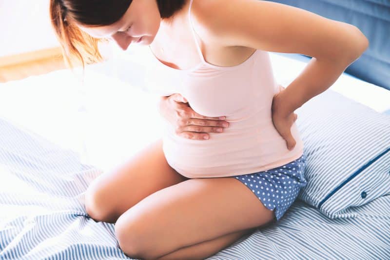 woman holding pregnant stomach