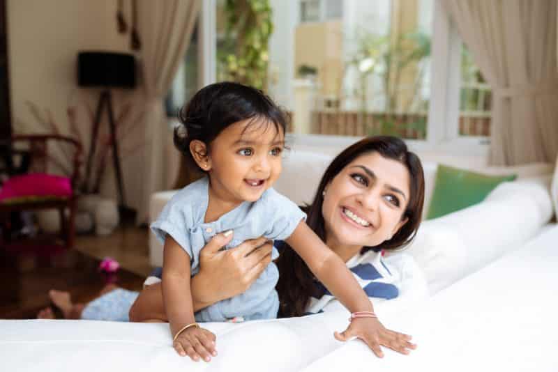 Indian mother and daughter playing together at home