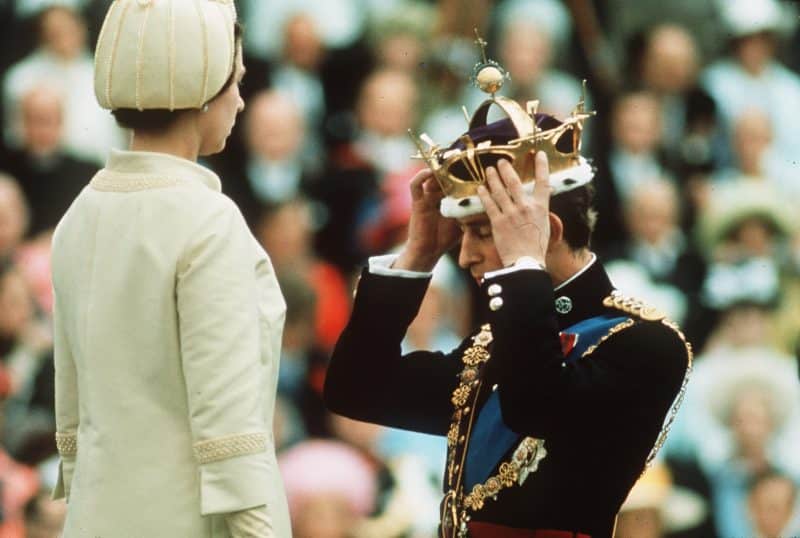 Prince Charles kneels before Queen Elizabeth as she crowns him Prince of Wales